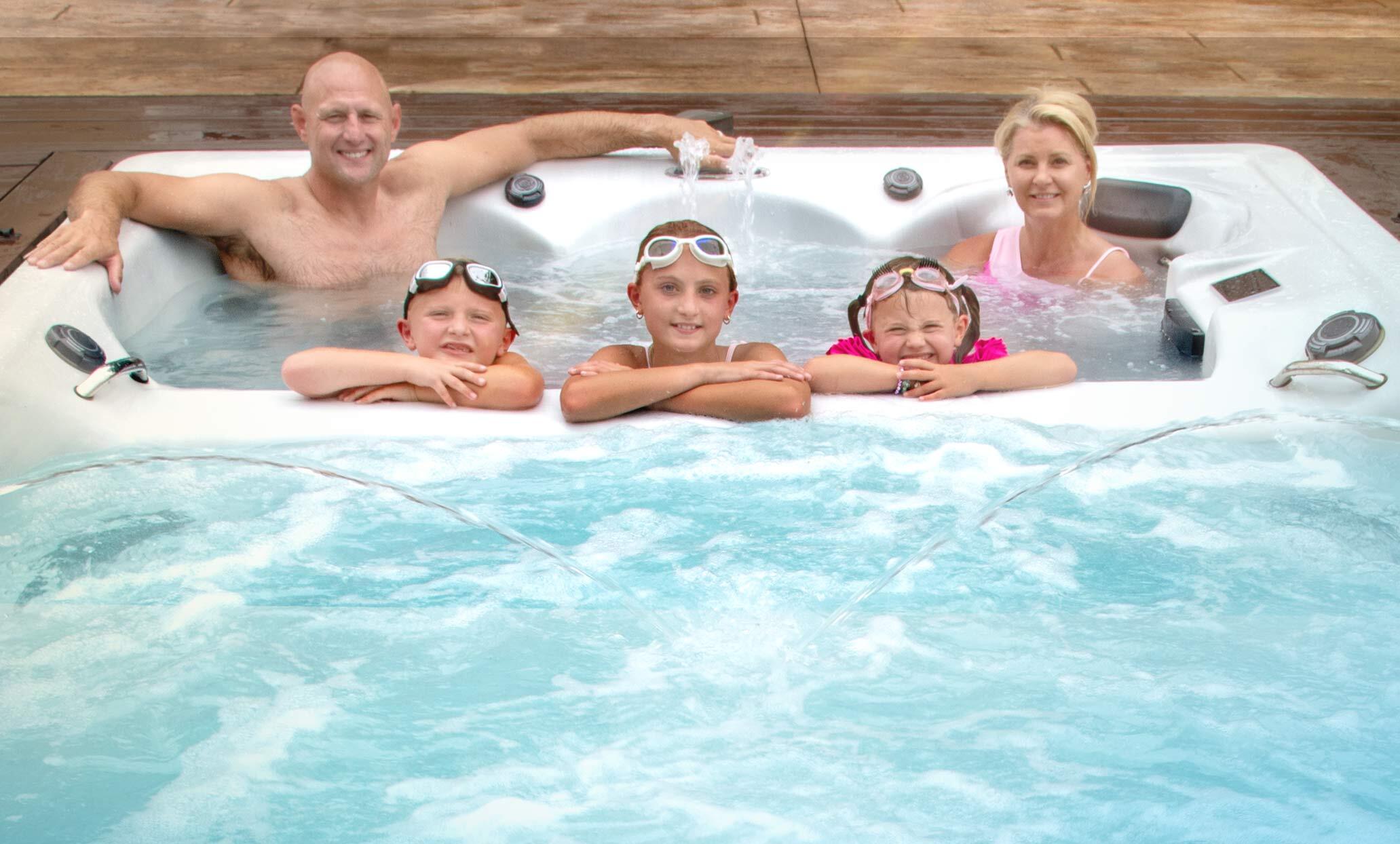 Family in a Master Spas swim spa