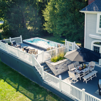 A swim spa surrounded by a deck.