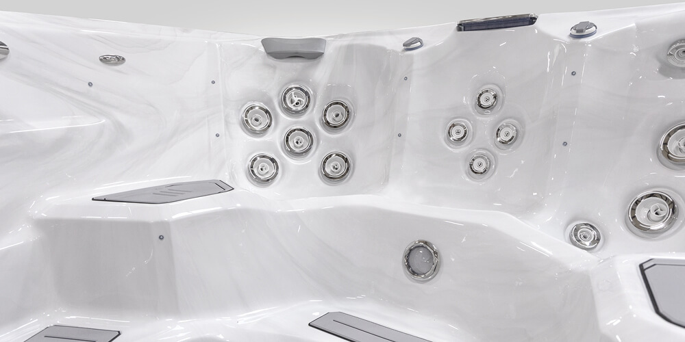 View on the inside of an H2X Fitness swim spa without water focusing on jets.