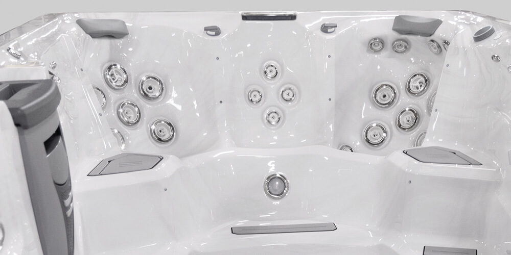 View on the inside of an H2X Fitness swim spa without water focusing on jets.