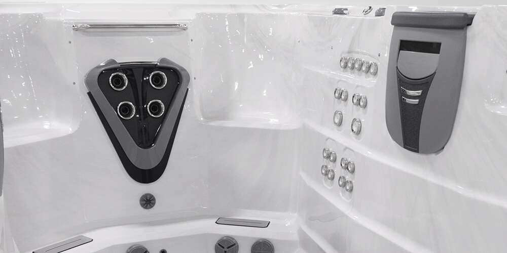 View on the inside of an H2X Fitness swim spa without water focusing on jets.