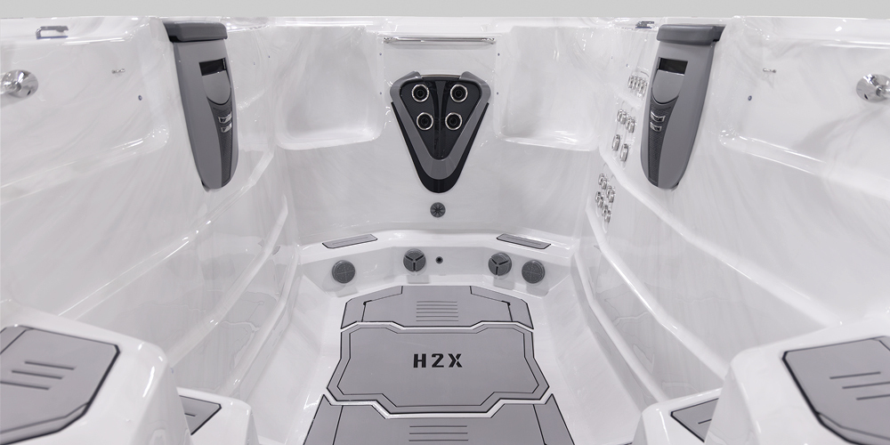 View on the inside of an H2X Fitness swim spa without water focusing on jets.