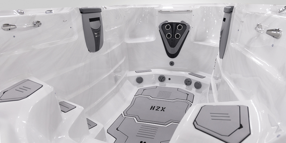 View on the inside of an H2X Fitness swim spa without water focusing on jets.